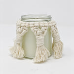 Unlit candle jar with a macrame cover. 