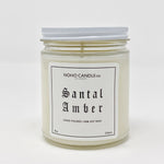 A 9-oz glass jar containing 8 ounces of white Santal Amber candle.  The lid is white and screws on.