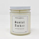 A 9-oz glass jar containing 8 ounces of white Santal Amber candle.  The lid is white and screws on.