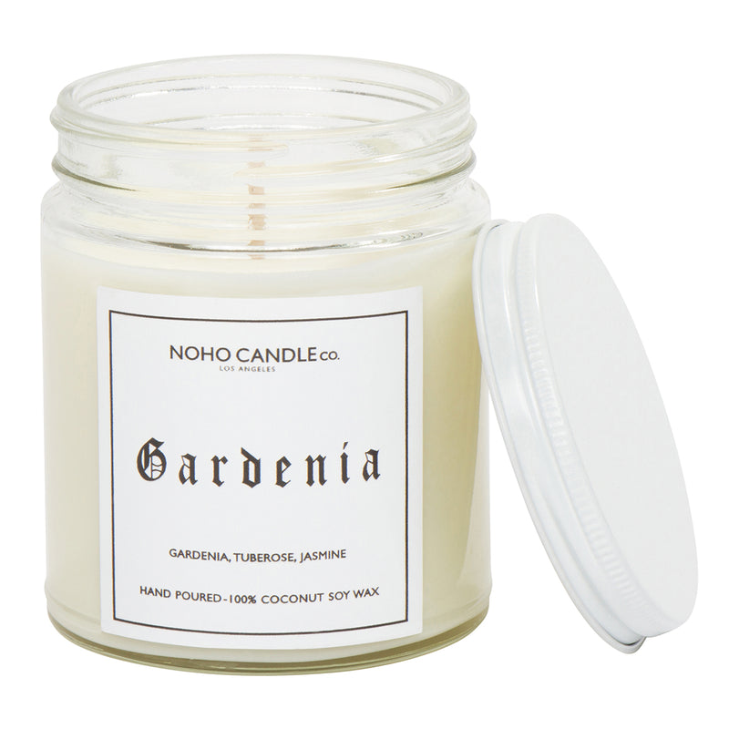 A clear 9oz jar with 8oz of white candle inside it.  The lid is white and screws on.