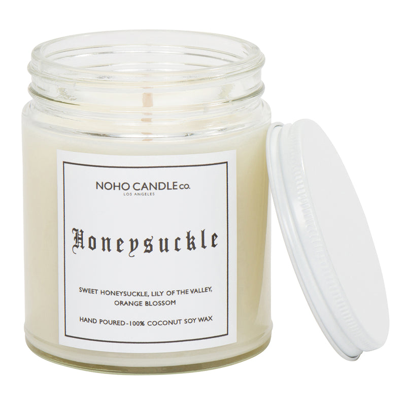 A clear 9oz jar with 8oz of white candle inside it.  The lid is white and screws on.