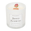 A 10oz Wood Wick Honey Jasmine Floral Collection candle.  The wax is white and there is a single dried, natural rose positioned near the edge.  The candle has been poured into a white translucent glass that comes with a clear, translucent lid.