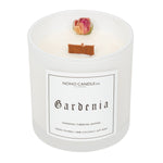 A 10oz Wood Wick Gardenia candle from the Floral collection.  The wax is white and there is a single dried, natural rose near the edge.  The candle is inside a white translucent glass that comes with a clear plastic lid.