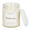 A clear 9oz jar with 8oz of white candle inside it.  The lid is white and screws on.