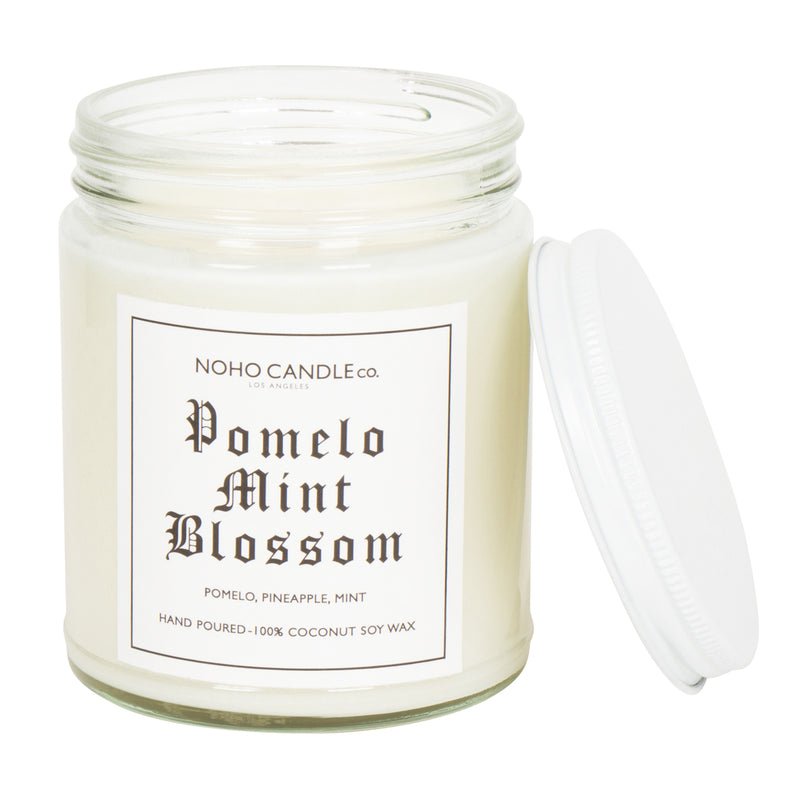 A clear 9oz jar with 8oz of white candle inside it.  The lid is white and screws on.