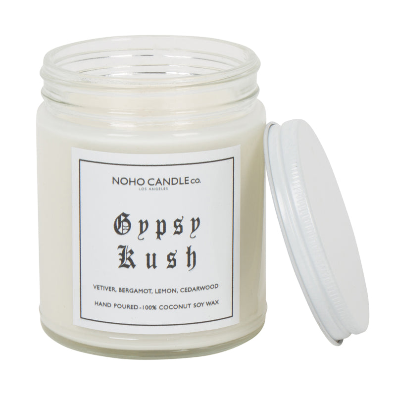 An 8oz short Gypsy Kush candle.  The wax is white, the jar is clear, and the lid is white and screws on. 